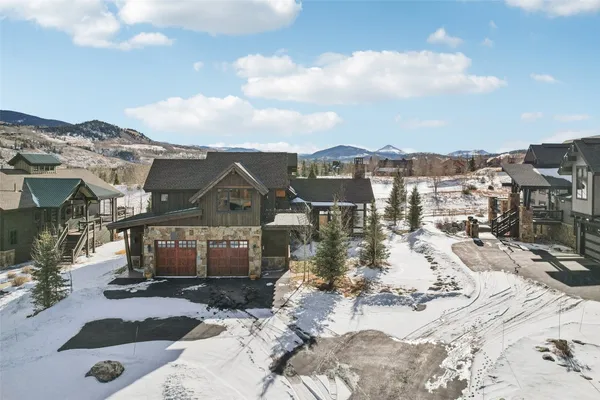 a view of a houses with a snow in the background
