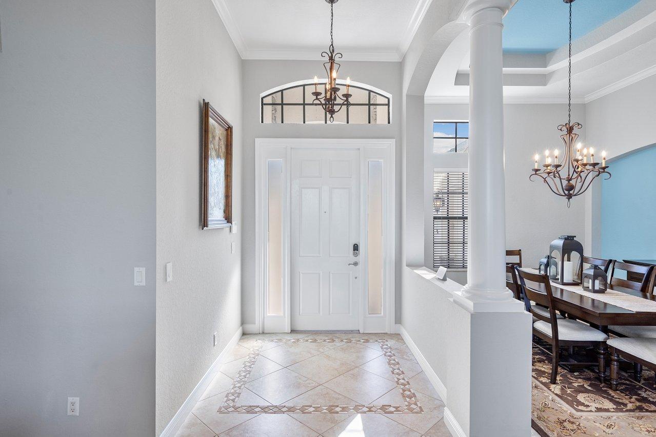 9283 Equus Circle Boynton Beach, FL 33472 - Photo 5 of 48 a view of a dining room with furniture and a chandelier