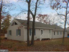 129 Breton Road Brick, NJ 08723 - Photo 3 of 8 front view of a house with a dry trees