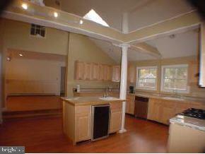 129 Breton Road Brick, NJ 08723 - Photo 5 of 8 a kitchen with stainless steel appliances granite countertop a stove a sink and a refrigerator