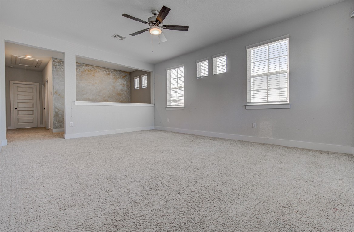 822 Wild Pecan Loop Buda, TX 78610 - Photo 20 of 33 Empty room with attic access and a ceiling fan
