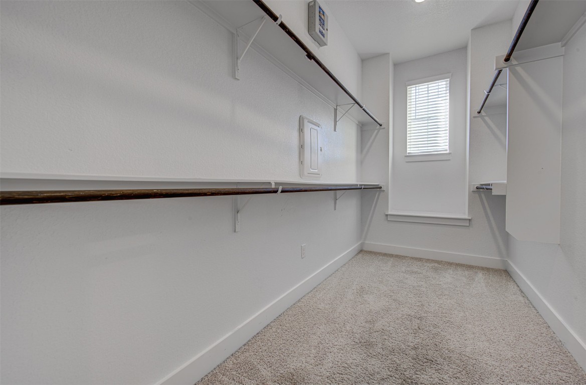 822 Wild Pecan Loop Buda, TX 78610 - Photo 26 of 33 Spacious closet featuring light colored carpet and electric panel