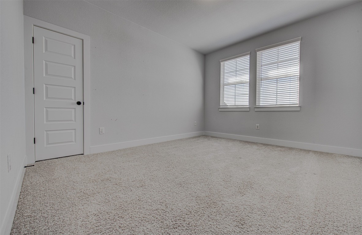 822 Wild Pecan Loop Buda, TX 78610 - Photo 28 of 33 Spare room featuring baseboards