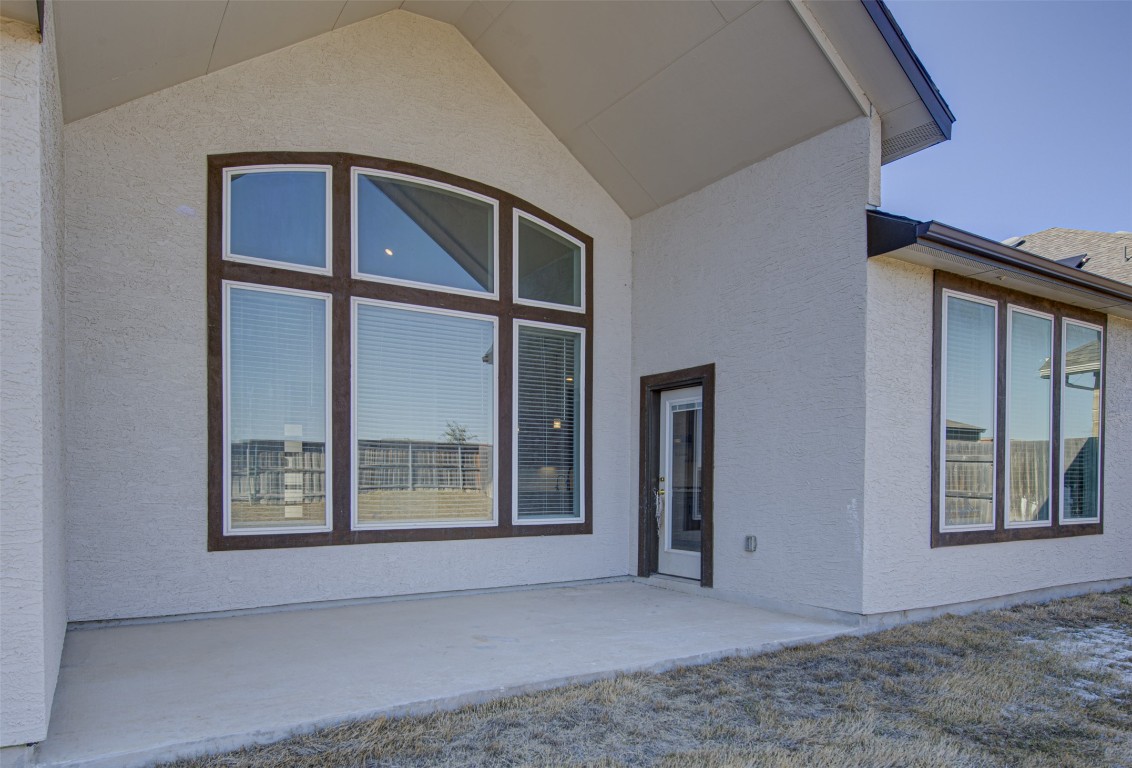 822 Wild Pecan Loop Buda, TX 78610 - Photo 29 of 33 Property entrance with a patio and stucco siding