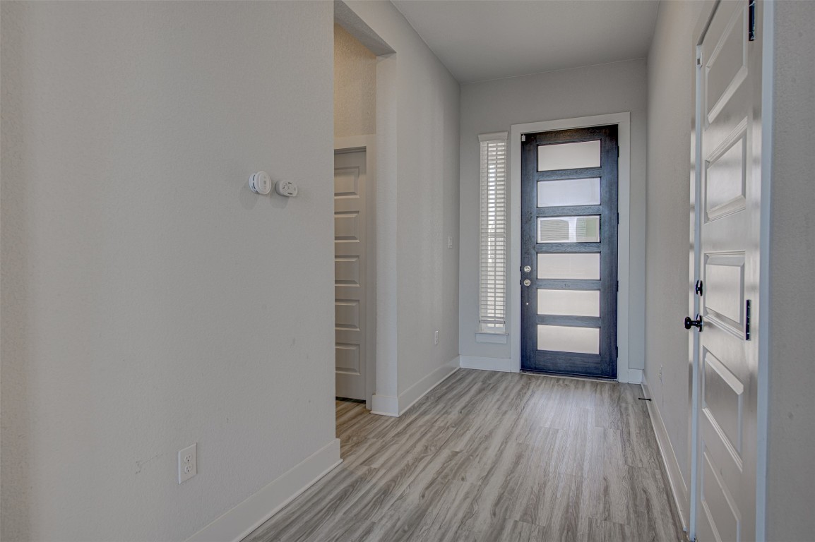 822 Wild Pecan Loop Buda, TX 78610 - Photo 9 of 33 Entryway with baseboards and light wood-style flooring