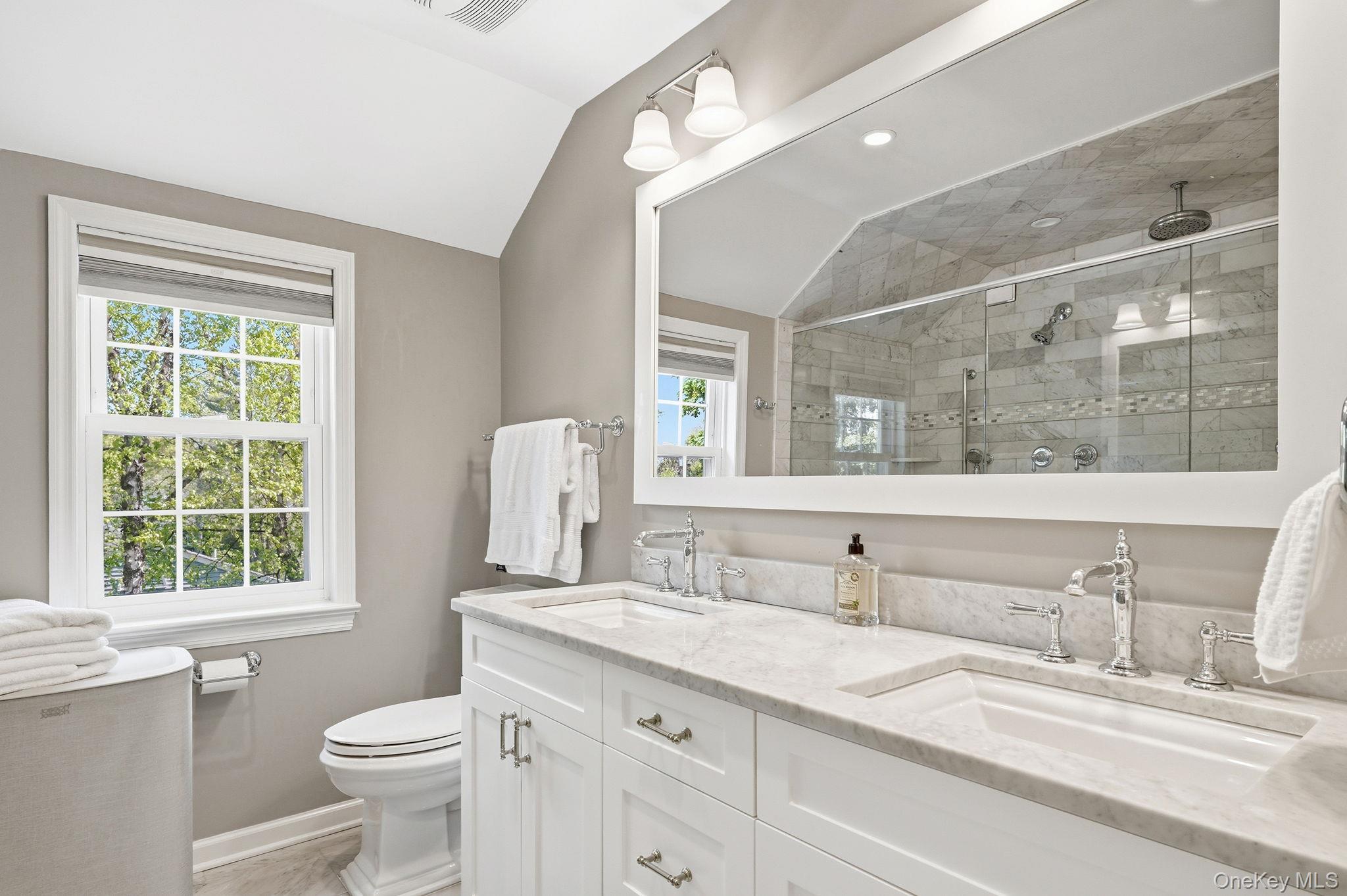 7 Morehead Drive Rye, NY 10580 - Photo 19 of 34 a bathroom with a granite countertop sink a large mirror a toilet and a window