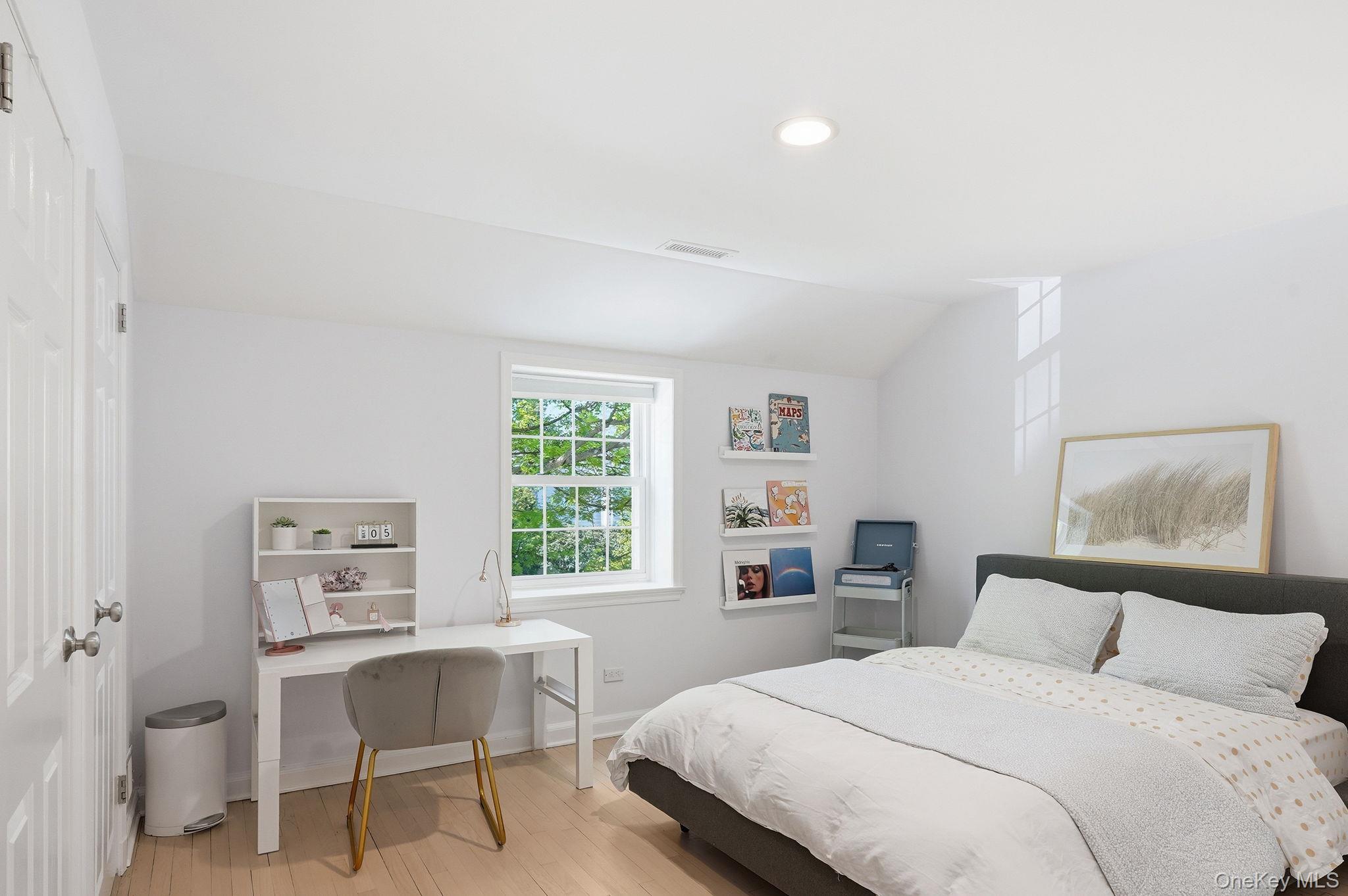 7 Morehead Drive Rye, NY 10580 - Photo 21 of 34 a bedroom with a bed and a table in it with window