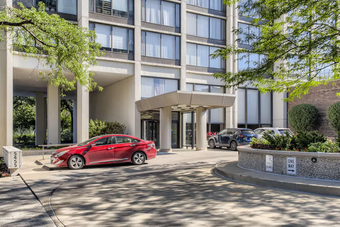 5455 North Sheridan Road, Unit 3105 Chicago, IL 60640 - Photo 2 of 11 a red car parked in front of a building