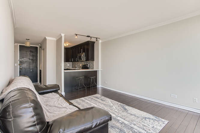 5455 North Sheridan Road, Unit 3105 Chicago, IL 60640 - Photo 4 of 11 a bedroom with a bed and furniture