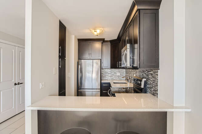 5455 North Sheridan Road, Unit 3105 Chicago, IL 60640 - Photo 7 of 11 a bathroom with a sink and a mirror