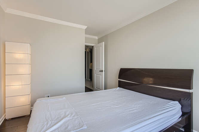 5455 North Sheridan Road, Unit 3105 Chicago, IL 60640 - Photo 9 of 11 a bedroom with a bed and a window