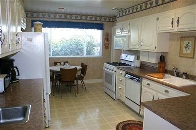 36 Ridgewood Drive San Rafael, CA 94901 - Photo 5 of 11 a kitchen with a stove a sink and a refrigerator
