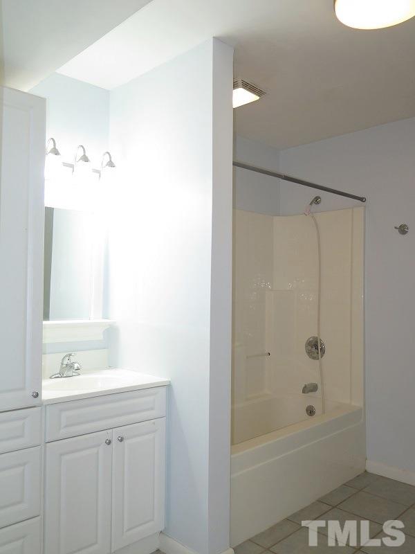 632 Buck Jones Road Raleigh, NC 27606 - Photo 15 of 20 a bathroom with a shower sink vanity and mirror