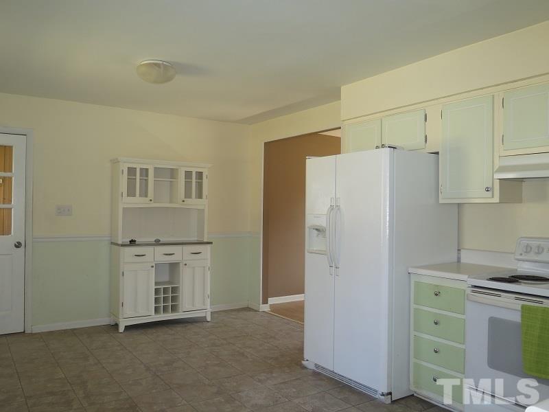 632 Buck Jones Road Raleigh, NC 27606 - Photo 6 of 20 a white refrigerator freezer and a stove sitting inside of a kitchen
