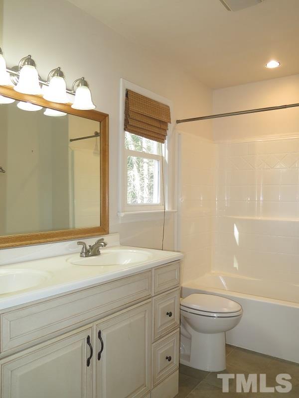 632 Buck Jones Road Raleigh, NC 27606 - Photo 8 of 20 a bathroom with a sink a toilet and shower