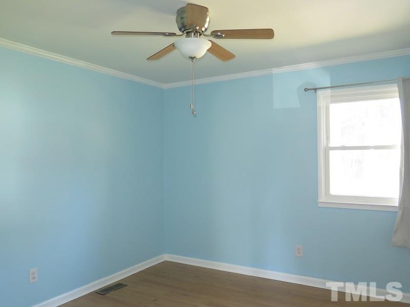632 Buck Jones Road Raleigh, NC 27606 - Photo 10 of 20 an empty room with a window and a fan