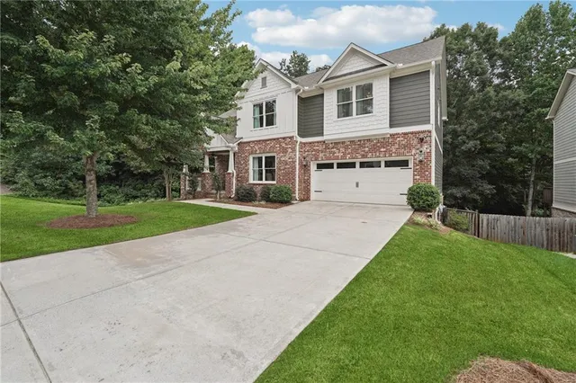 a front view of a house with a garden and yard