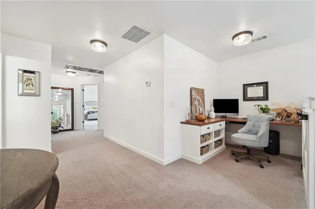 a view of a livingroom with workspace and a couch