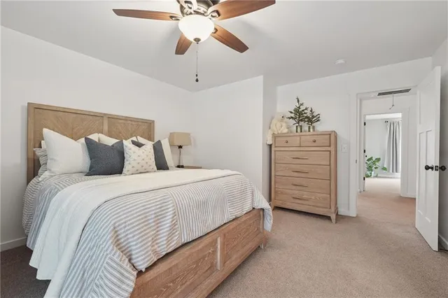 a spacious bedroom with a bed and a chandelier
