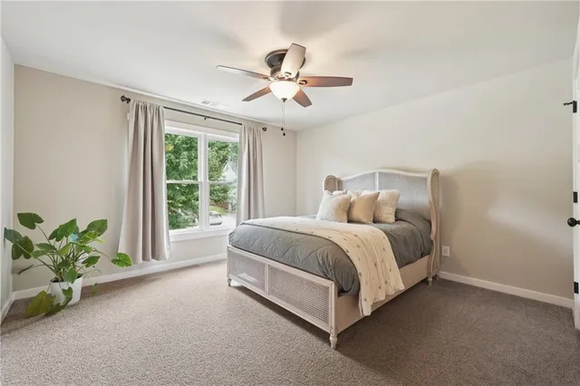 a spacious bedroom with a bed and a window