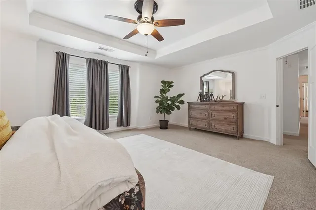a bedroom with a large bed and a chandelier