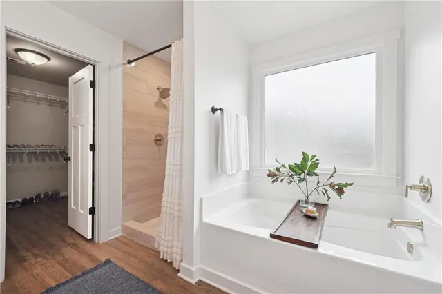 a bathroom with a tub and shower view