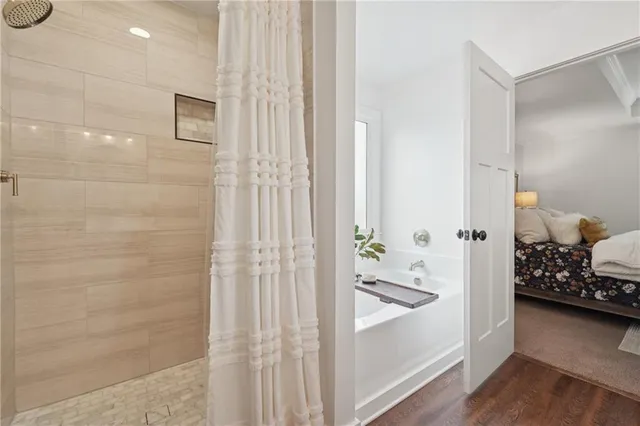 a bathroom with a bathtub and a shower