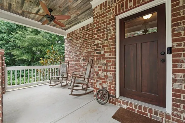 a view of a porch with wooden floor and iron stairs