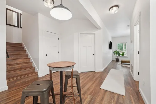 a view of a room with wooden floor and furniture