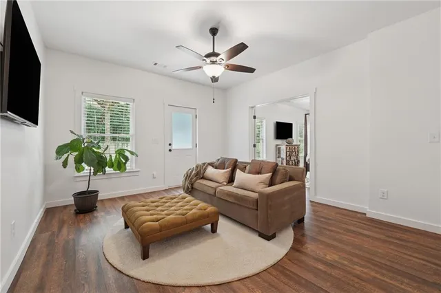 a living room with furniture and a potted plant