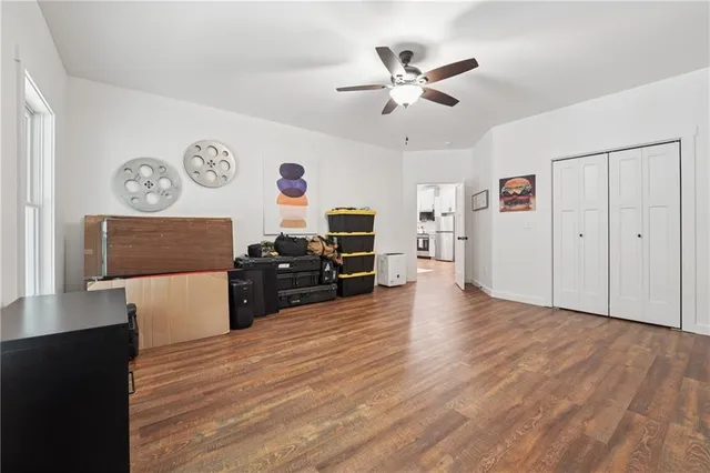 a view of a workspace with furniture and wooden floor