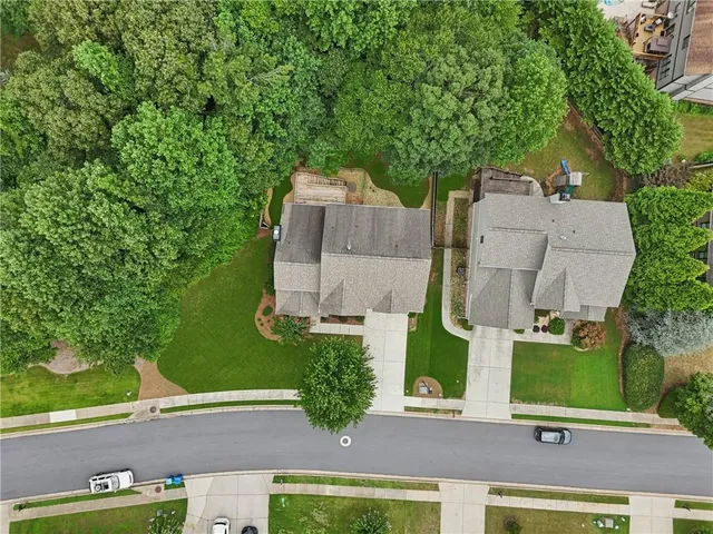 an aerial view of multiple houses with yard
