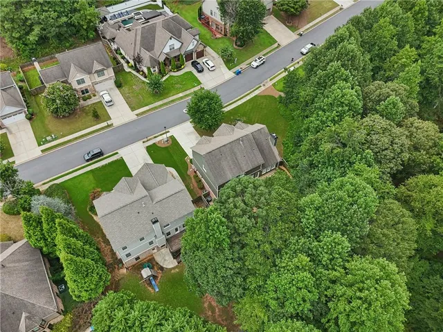 an aerial view of a house with a yard