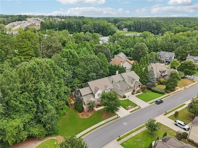 an aerial view of a house with a yard