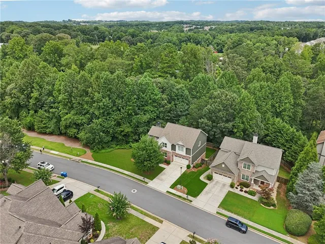 an aerial view of a house with a yard