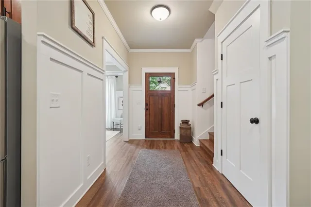 a view of a hallway with wooden floor and closet