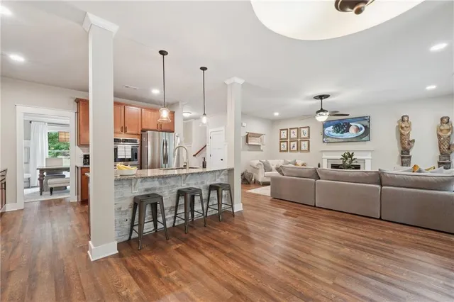 a living room with furniture and a wooden floor