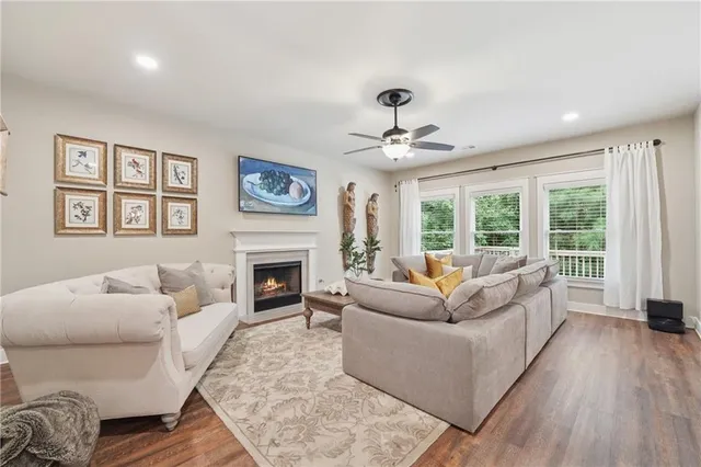 a living room with furniture a fireplace and a large window