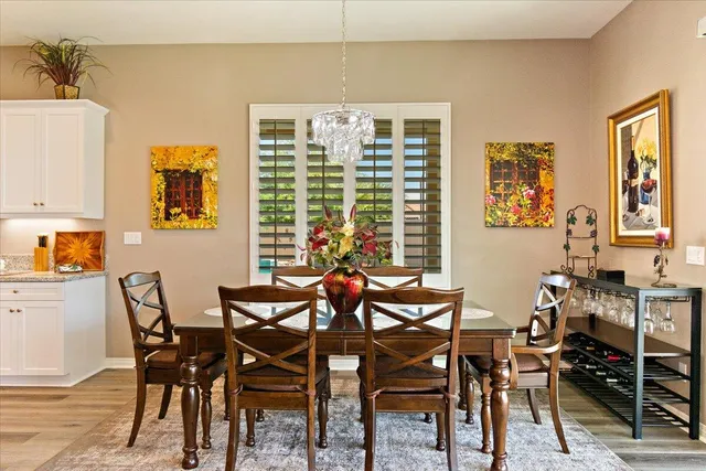 a view of a dining room with furniture large window and wooden floor