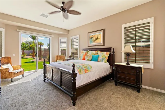 a bed sitting in a spacious bedroom next to a window