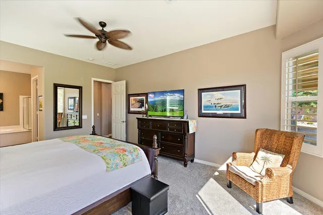 a bedroom with a bed a couch and a window