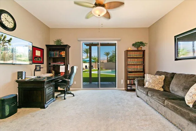 a livingroom with workspace couch and a window