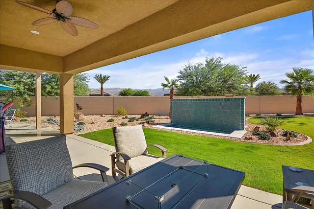 a view of a patio with table and chairs and potted plants