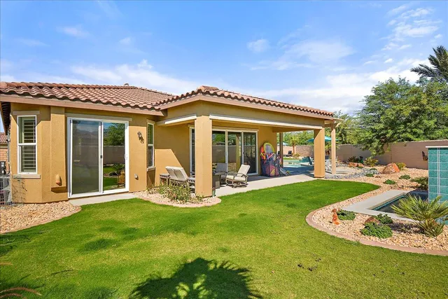 a view of a house with backyard porch and sitting area