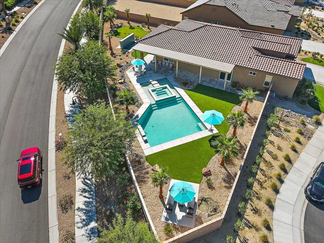 an aerial view of a house with a garden and swimming pool