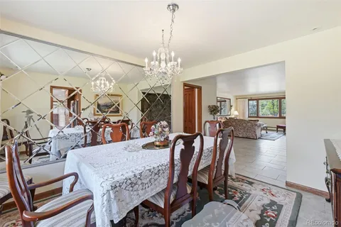 a view of a dining room with furniture and a chandelier