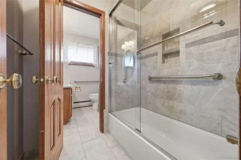 a bathroom with a bathtub and a shower