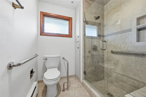 a bathroom with a toilet and a shower