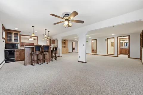 a view of a livingroom with furniture and chandelier fan