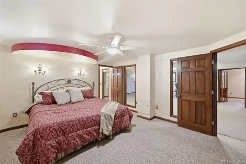 a bedroom with a large bed and a chandelier